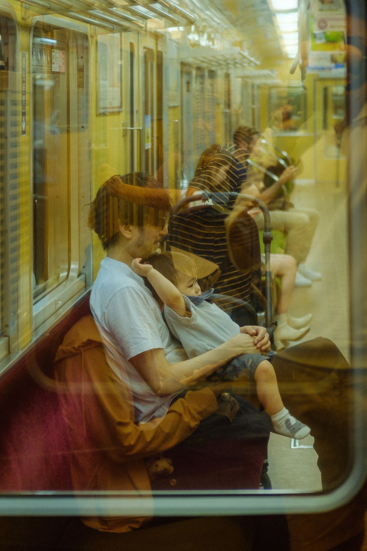 Passengers resting on a train, including a young couple leaning together by the window